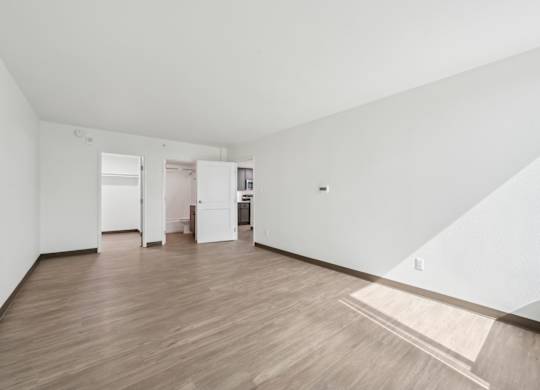 A room with wooden floors and white walls.