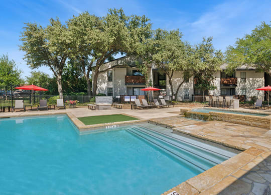 Community Swimming Pool with Pool Furniture at Summit Ridge Apartments located in Arlington, TX.
