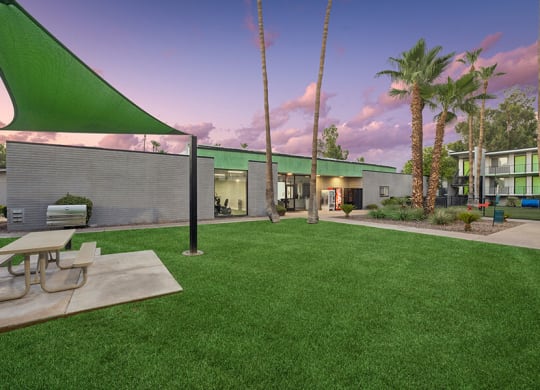 Outdoor BBQ Area with Canopy and Picnic Table at Arcadia on 49th Apartments located in Phoenix, AZ.