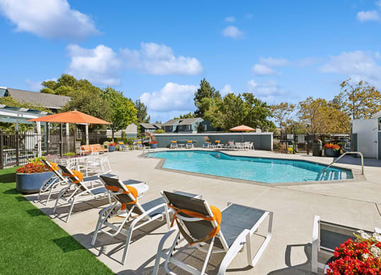 Community Swimming Pool with Pool Furniture at Bridges on Sunset Apartments located in Suisun City, CA.