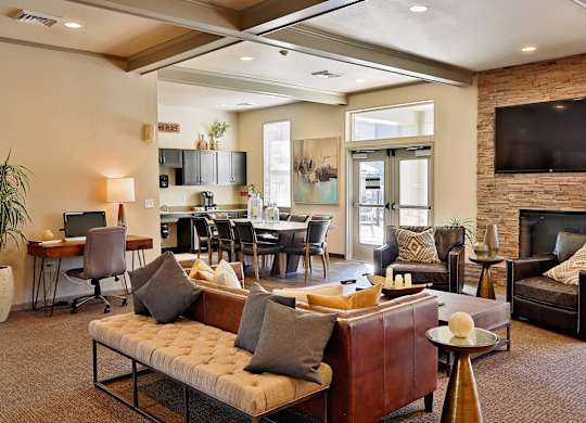 A living room with a couch, chairs, and a fireplace.