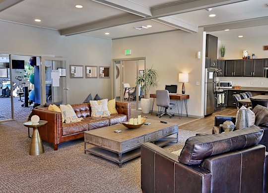 A living room with brown leather couches and a wooden coffee table.