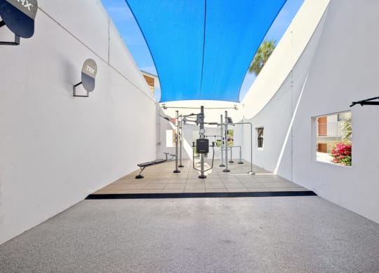 a gym with white walls and a blue ceiling