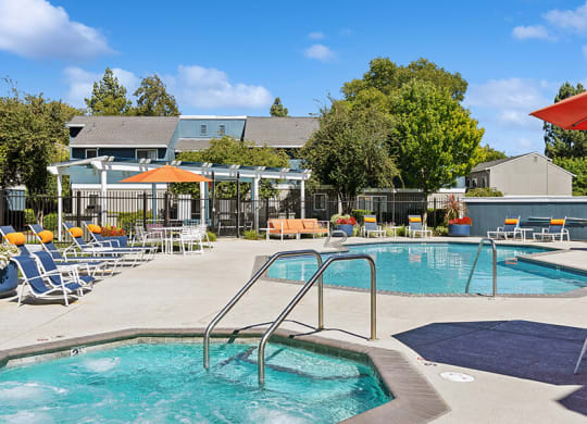 Community Swimming Pool with Pool Furniture at Bridges on Sunset Apartments located in Suisun City, CA.