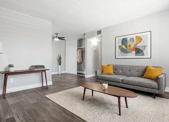 Model Living Room with Wood-Style Flooring at Accent on Rainbow Apartments located in Las Vegas, Nevada.