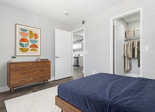 Model Bedroom with Wood-Style Flooring at Accent on Rainbow Apartments located in Las Vegas, Nevada.