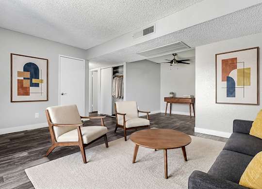 Model Living Room with Wood-Style Flooring at Accent on Rainbow Apartments located in Las Vegas, Nevada.