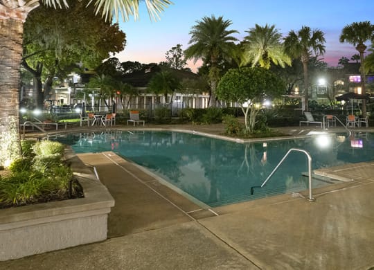 Community Swimming Pool with Pool Furniture at Fountains at Lee Vista Apartments in Orlando, FL.