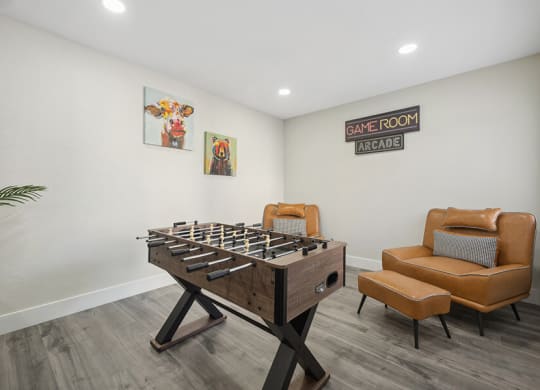 Community Clubhouse with Game Tables and Lounge Furniture at Villages at Metro Center Apartment located in Phoenix, AZ.
