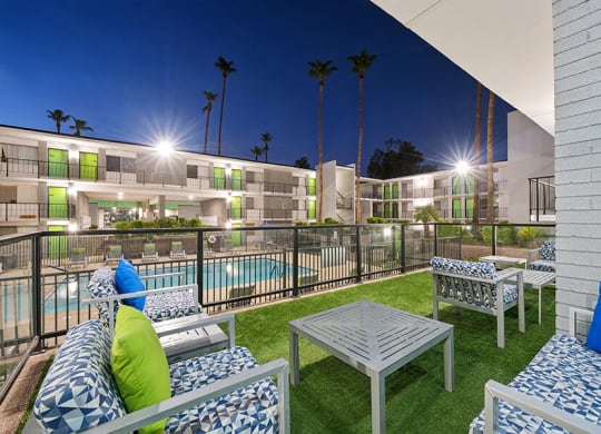 Outdoor Patio with Lounge Furniture and View of Pool at Arcadia on 49th Apartments located in Phoenix, AZ.