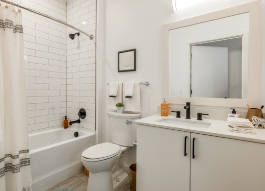 Model bathroom with a toilet sink and tub
