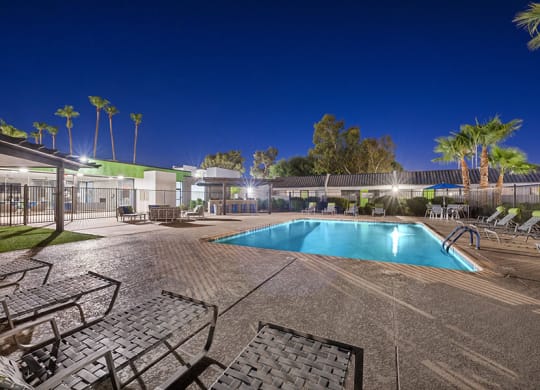 Community Swimming Pool with Pool Furniture at Arcadia on 49th Apartments located in Phoenix, AZ.