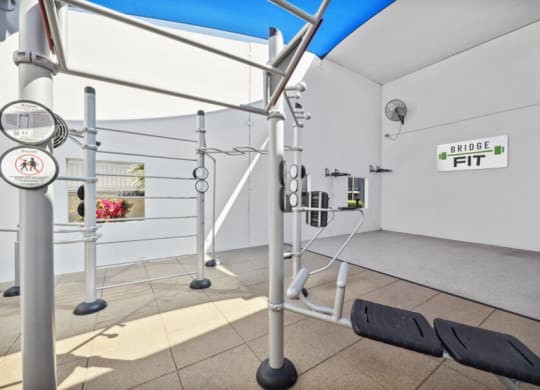 a workout room with weights and ropes in a gym