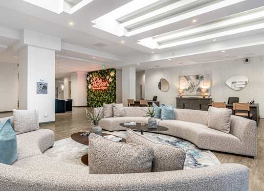 A modern living room with a grey sofa and a coffee table.