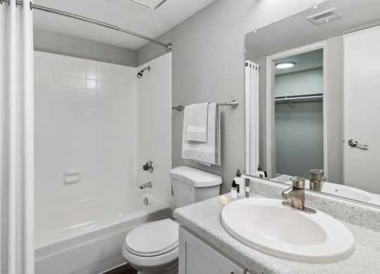 a white bathroom with a sink and a toilet