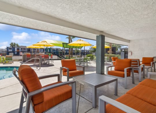 our apartments have a large patio with tables and chairs and a pool