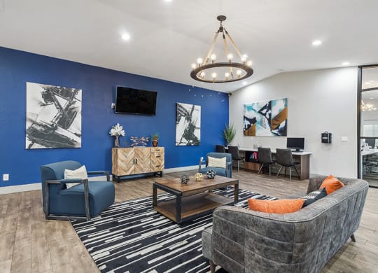 a living room with a blue wall and a couch and a table