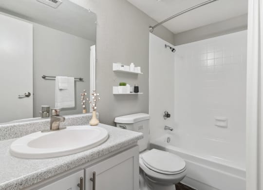 a white bathroom with a sink and a toilet