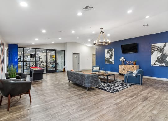 a lobby with couches and chairs and a tv