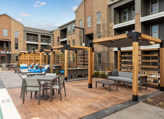 Outdoor lounge space with covered seating at Alta 3Eighty Apartments in Aubrey, TX