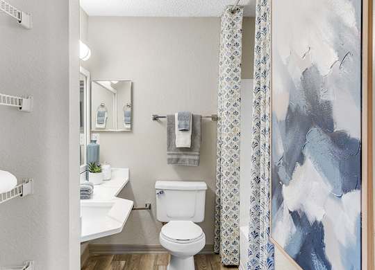 Model Bathroom with Wood-Style Flooring and Shower/Tub at Mirage on Kernan Apartments located in Jacksonville, FL.
