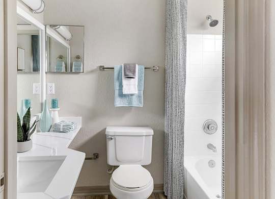Model Bathroom with Wood-Style Flooring and Shower/Tub at Mirage on Kernan Apartments located in Jacksonville, FL.