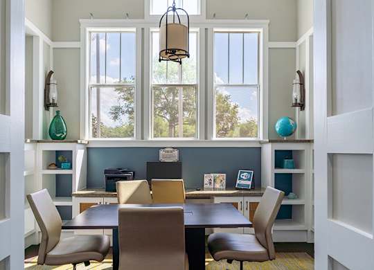 A dining room with a table and chairs.