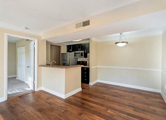 Model living room next to kitchen at Bridges at Bayside in St. Petersburg, Florida.