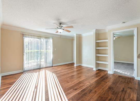 Model living room with wood-style flooring at Bridges at Bayside in St. Petersburg, Florida.