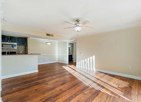 Model living room with wood-style flooring at Bridges at Bayside in St. Petersburg, Florida.