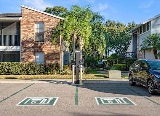 Apartment building exterior and EV charging station at Grand Pavilion Apartments in Tampa, FL