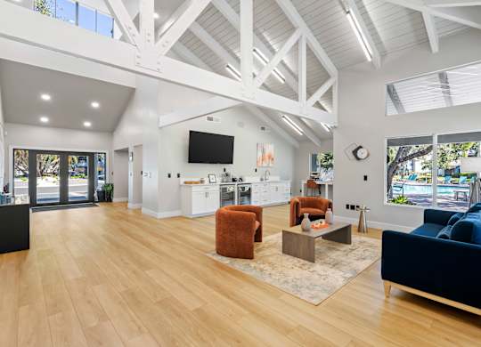 Community clubhouse seating area on wood flooring and vaulted ceilings at Huntington Place in Sarasota, Florida.