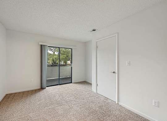 Model living room with sliding door at Rosehill Preserve in Orlando, FL