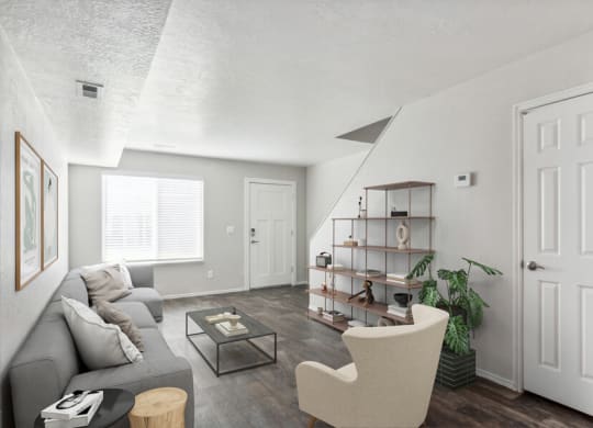 Model living room with a grey couch and a coffee table