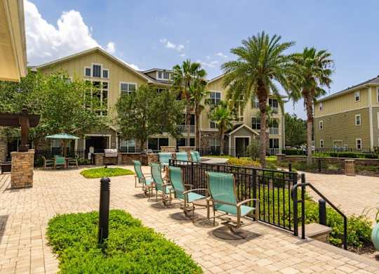 Apartment exterior with lush landscaping at Bridges at Crosstown in Tampa, FL