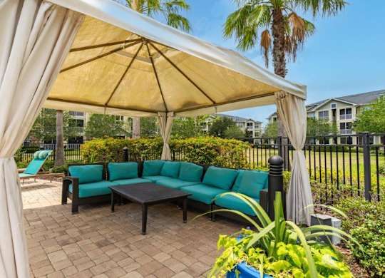 A patio with a canopy and a bench at Bridges at Crosstown in Tampa, FL