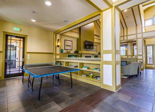 A room with a ping pong table and a TV  at Bridges at Crosstown in Tampa, FL