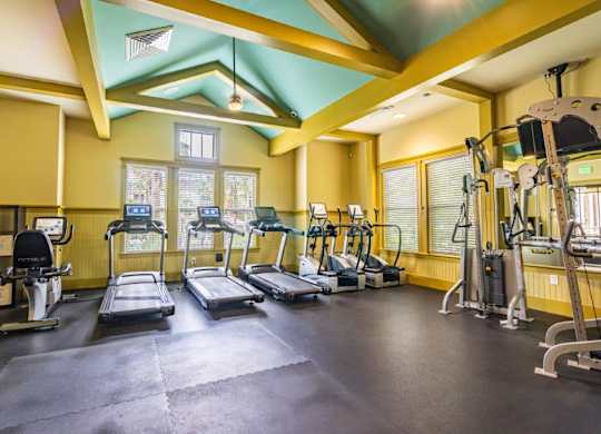 Fitness center with treadmills, elliptical machines, and other exercise equipment at Bridges at Crosstown in Tampa, FL
