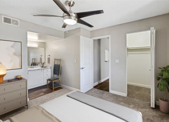 a bedroom with a bed and a ceiling fan