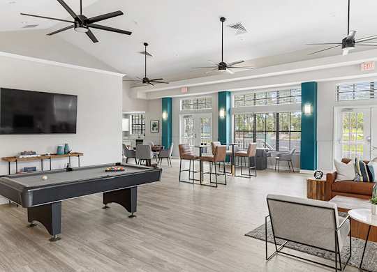 Community Clubhouse with Game Tables and Lounge Furniture at Mirage on Kernan Apartments located in Jacksonville, FL.