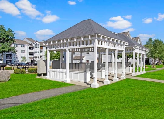 a large white gazebo in the middle of a grassy area