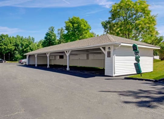 a white building with a parking lot in front of it