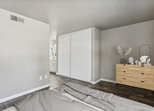a bedroom with a bed and a dresser