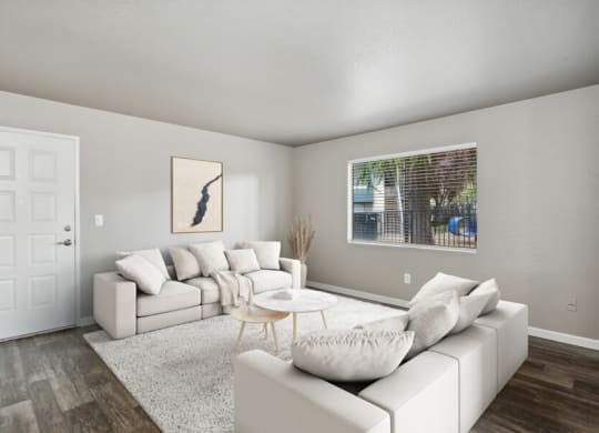 a living room with white couches and a coffee table