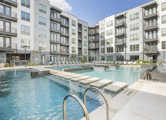a swimming pool in front of an apartment building