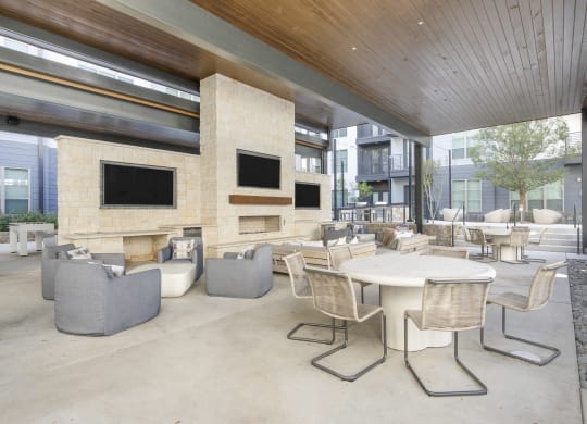 the lobby of a building with tables and chairs