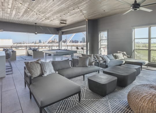 a living room with couches and a table and a view of a bridge