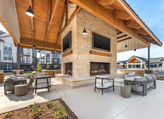 A patio with a fireplace and seating area.