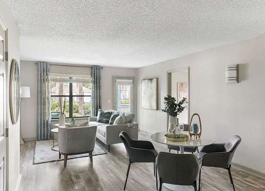 Model Living Room with Wood-Style Flooring at Mirage on Kernan Apartments located in Jacksonville, FL.