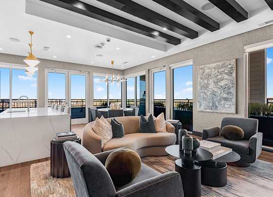 Community Clubhouse Lounge Area and Kitchenette at Ovation at Galatyn Park Apartments located in Richardson, TX.